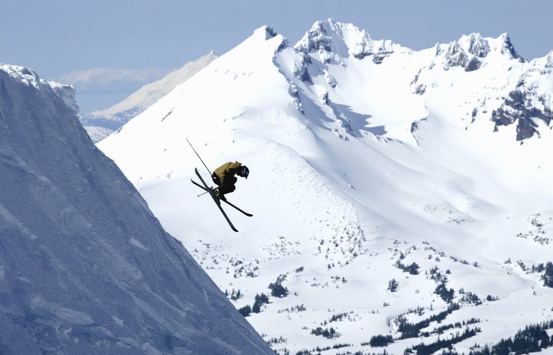 This undated photo released by Mt. Bachelor, Inc. shows a skier dropping off of a cornice from the summit at Mt. Bachelor Ski Resort near Bend, Ore. (AP Photo/Mt. Bachelor, Inc.) ** NO SALES **