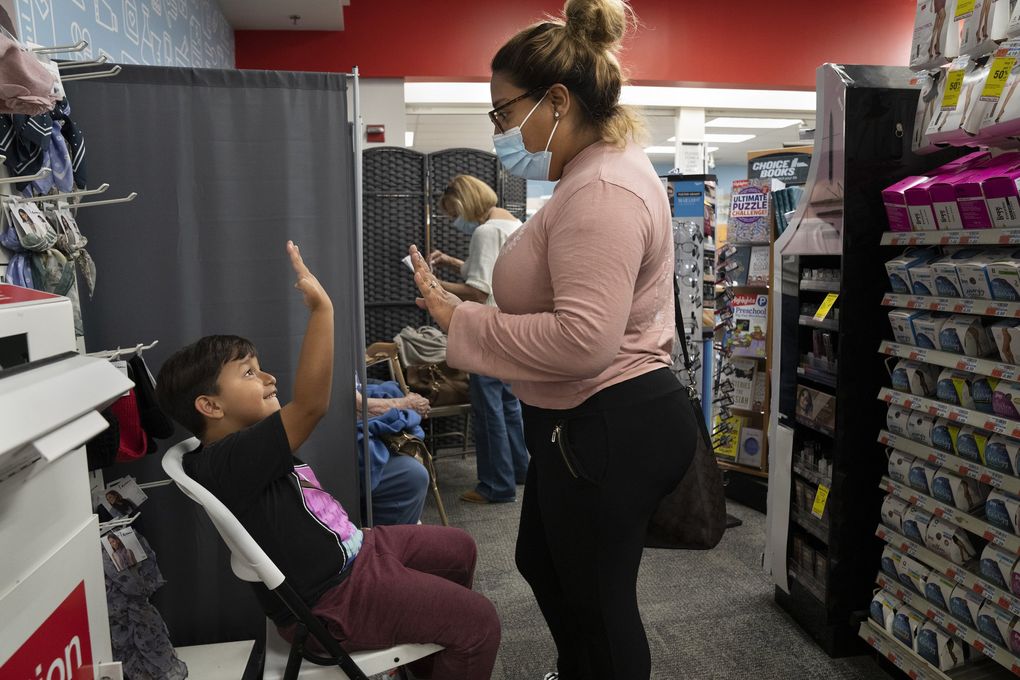 Xibelli Valdespino, who had worried about side effects, with her son after getting vaccinated in the Bronx, New York. (James Estrin / The New York Times)