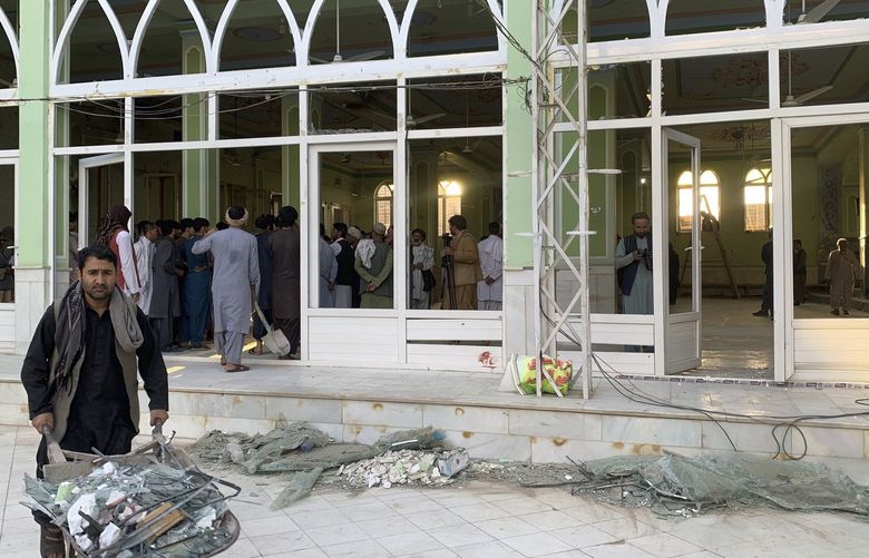 People view the damage inside of a mosque following a suicide bombers attack in the city of Kandahar, southwest Afghanistan, Friday, Oct. 15, 2021. Suicide bombers attacked a Shiite mosque in southern Afghanistan that was packed with worshippers attending Friday prayers, killing several people and wounding others, according to a hospital official and a witness. (AP Photo/Sidiqullah Khan) XRG113 XRG113