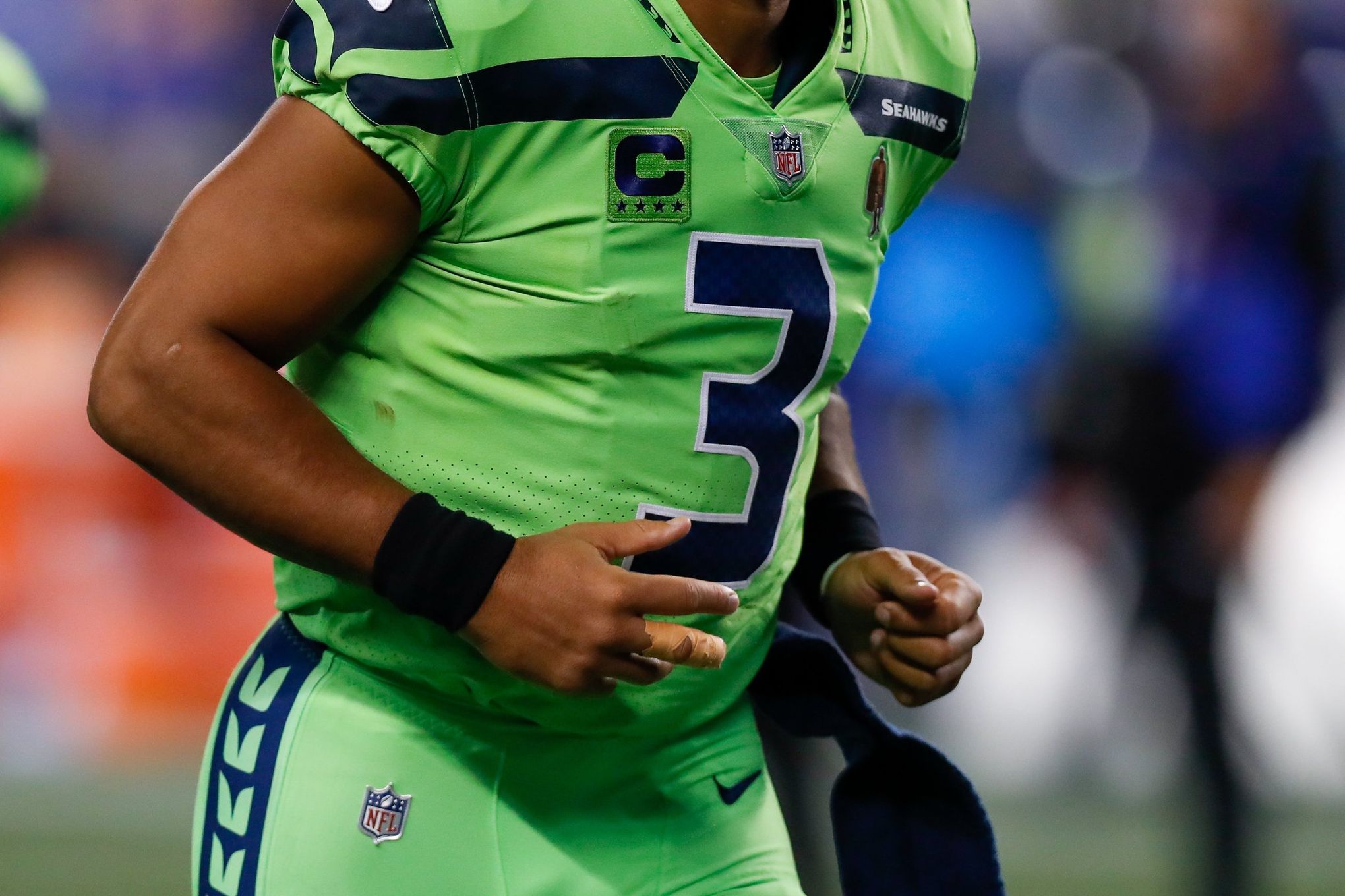 Seattle Seahawks quarterback Russell Wilson (3) hands pff to running back  Chris Carson (32) during the second half of an NFL football game against  the Carolina Panthers in Charlotte, N.C., Sunday, Dec.