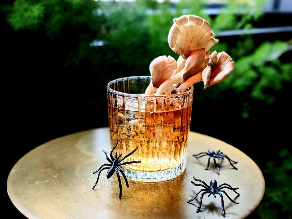 The Mountaineering Club, a rooftop bar in the University District, will serve psychedelic-inspired drinks like the Monster Mush(room), made with mezcal and mole bitters, for spooky season 2021. (Courtesy of The Mountaineering Club)