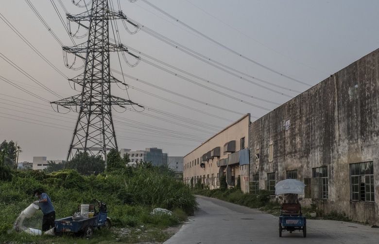 FILE — Power lines in Dongguan, China on Sept. 27, 2021. The government has imposed limits on energy use, as a part of a broader response to climate change concerns. Gilles Sabrié/The New York Times) XNYT20