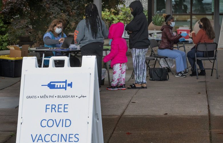 Marietta Torres-Alexanderson, a coordinator with Vaccine 6M Geriatrics, (l) registers women waiting to get the COVID vaccine while Betie Tesfaye, R. N. (2nd from right), gets ready to give a woman a shot at Highline College Monday, October 11, 2021.  The women and others are there every Monday from 10 a.m. – 2:30 p.m. to give shots to anyone who would like one for free.  They provide Johnson & Johnson, Maderna and Pfizer vaccines, as well as booster shots.  They have been at the campus since August and plan to be there until next year.  Any K-12 educators/school staff, health care workers or state workers will have to be fully vaccinated by Oct. 18 if they want to keep their jobs (with some leeway depending on union negotiations).

Highline College  is located at 2400 S 240th St. in Des Moines. 218481