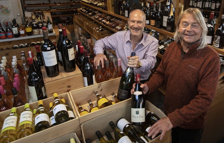 Spencer Jacobs, left, and Gene Yelden are the new owners of McCarthy & Schiering wine merchants, Wednesday, Oct. 20, 2021 in Seattle’s Ravenna neighborhood. 218569