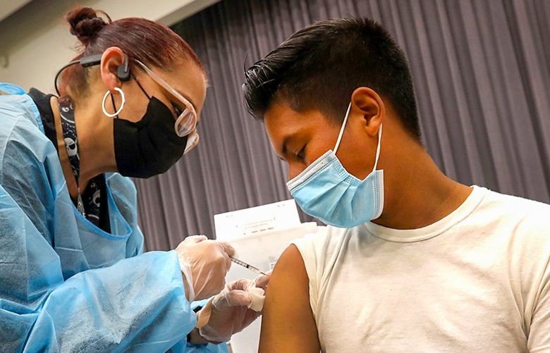 Student D’Marco Ahumada, 16, is vaccinated at San Pedro High School in May. Gov. Gavin Newsom has announced a statewide vaccine mandate for eligible California students.