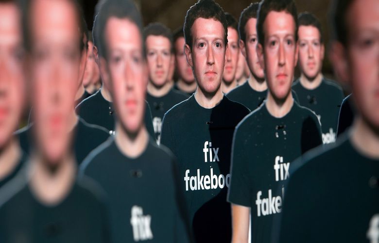 One hundred cardboard cutouts of Facebook founder and CEO Mark Zuckerberg stand outside the US Capitol in Washington, DC, April 10, 2018. Advocacy group Avaaz called attention to what the groups said were hundreds of millions of fake accounts spreading disinformation on Facebook. (Saul Loeb/AFP/Getty Images/TNS)