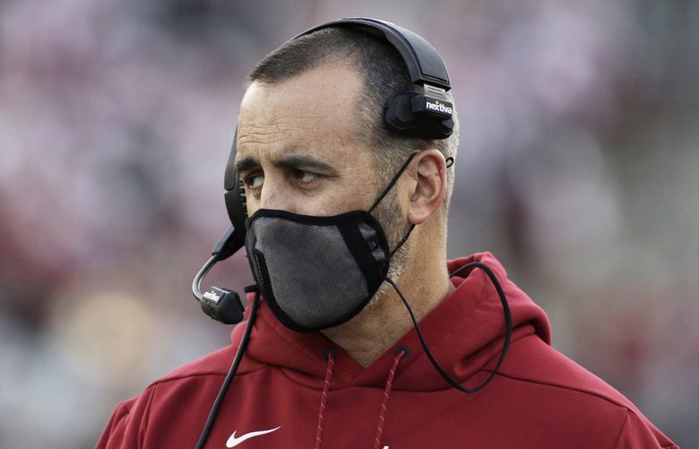 FILE – In this Saturday, Oct. 16, 2021, file photo, Washington State coach Nick Rolovich watches during the first half of an NCAA college football game against Stanford in Pullman, Wash. The NHL suspending San Jose’s Evander Kane 21 games for submitting a fake vaccination card and Washington State firing football coach Nick Rolovich for failing to comply with a vaccine mandate Monday provided two more reminders of the impact the coronavirus is still having on professional and college sports. (AP Photo/Young Kwak, File) NYDD205 NYDD205