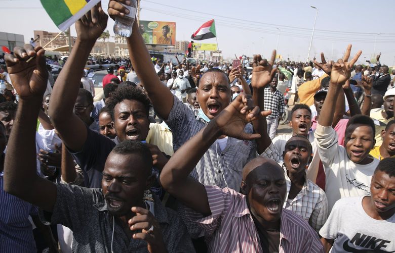 Sudanese demonstrators take to the streets of the capital Khartoum to demand the government’s transition to civilian rule in Khartoum, Sudan, Thursday, Oct. 21, 2021. The relationship between military generals and Sudanese pro-democracy groups has deteriorated in recent weeks over the country’s future. (AP Photo/Marwan Ali) DV108 DV108