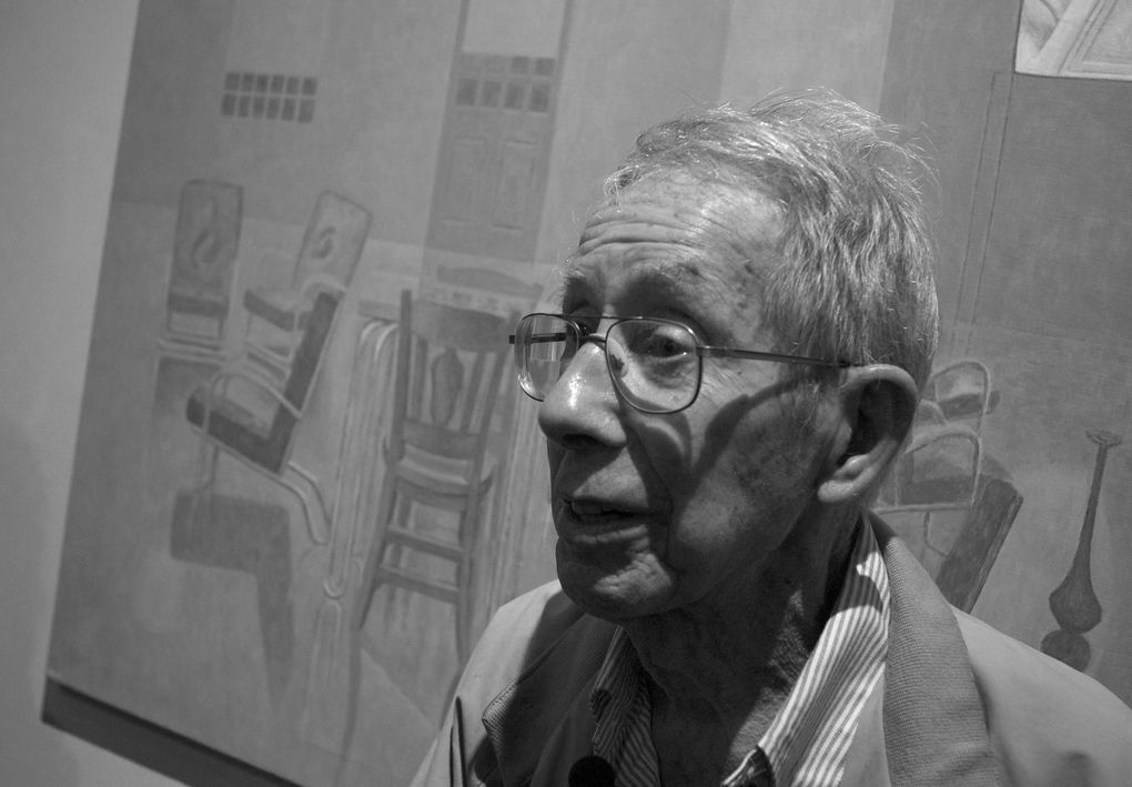 Artist David Byrd, who had his first exhibition at the age of 87, stands by a painting at Greg Kucera Gallery from his series based on his 30-year experience as an orderly at a Veterans Administration mental hospital. (Courtesy of Arthur Bacon)