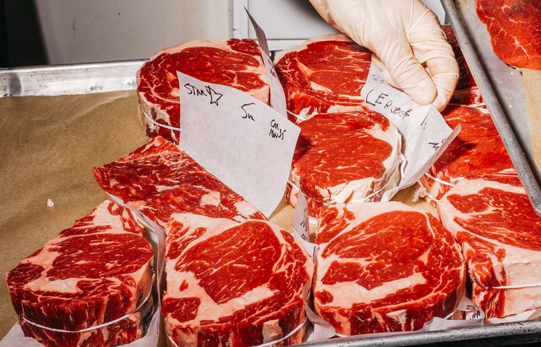 Beef is dry-aged in the meat cooler at Bateau in Seattle, Aug. 25, 2021. When it reopened in the spring, the restaurant offered a steak aged longer – more than 400 days – than the pandemic was at that point. (Kyle Johnson/The New York Times) XNYT91