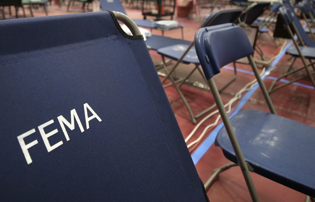 FILE – In this March 24, 2020, file photo, a portable cot with the Federal Emergency Management Agency logo FEMA printed on the backrest, along with other cots, line the basketball court at a makeshift medical facility in a gymnasium at Southern New Hampshire University in Manchester, N.H. On Friday, Oct. 22, The Associated Press reported on stories circulating online incorrectly claiming FEMA workers aren’t subject to a vaccine mandate, and also falsely asserting that they’re being used to replace health care personnel who refuse to comply with such mandates. (AP Photo/Charles Krupa, File) NYNN101 NYNN101