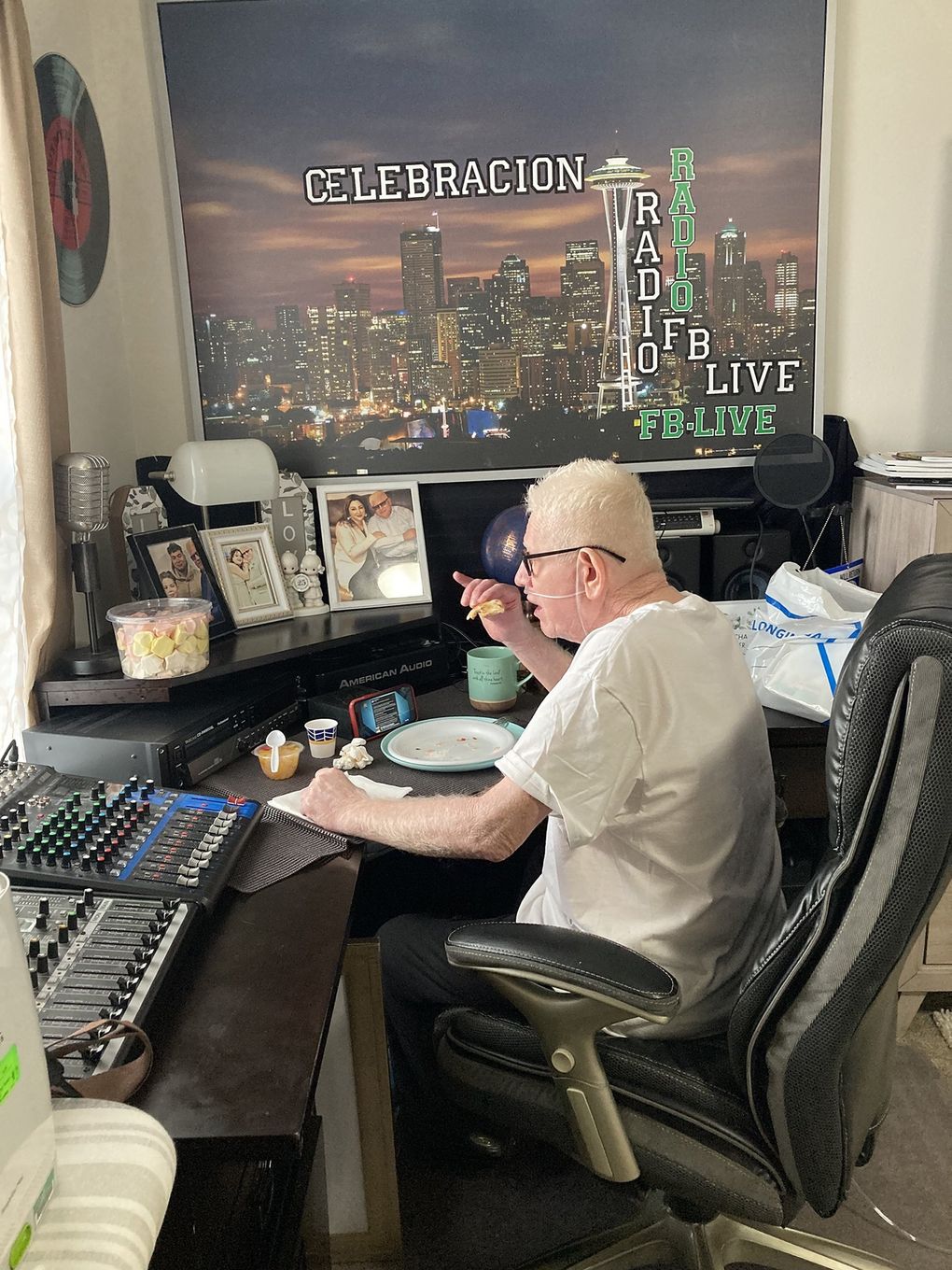 Trying to regain a slice of normalcy, Hector Garcia sits at a desk with the consoles he used to use for his Christian radio program. (Courtesy of Lizbeth Garcia)