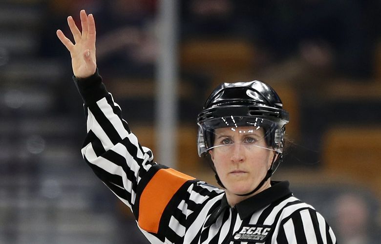 In this Feb 4, 2019, file photo, referee Katie Guay watches a Boston College line change during a Beanpot Tournament NCAA college hockey game against Harvard in Boston. Guay and Kirsten Welsh were among four females selected by the NHL on Friday, Sept. 6, 2019, to be the first women to work as on-ice officials at several prospect tournaments taking place across the country this weekend. The other two women selected were Kelly Cooke and Kendall Hanley. (AP Photo/Winslow Townson, FIle)