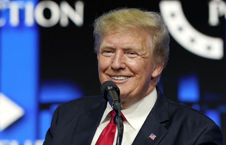FILE – In this July 24, 2021, file photo former President Donald Trump smiles as he pauses while speaking to supporters at a Turning Point Action gathering in Phoenix. Digital World Acquisition Corp., the company planning to bring President Donald Trumpâ€™s new media venture to the stock market, soared further on Friday, Oct. 22, 2021 amid another frenzy of trading.  (AP Photo/Ross D. Franklin, File) NYDD202 NYDD202