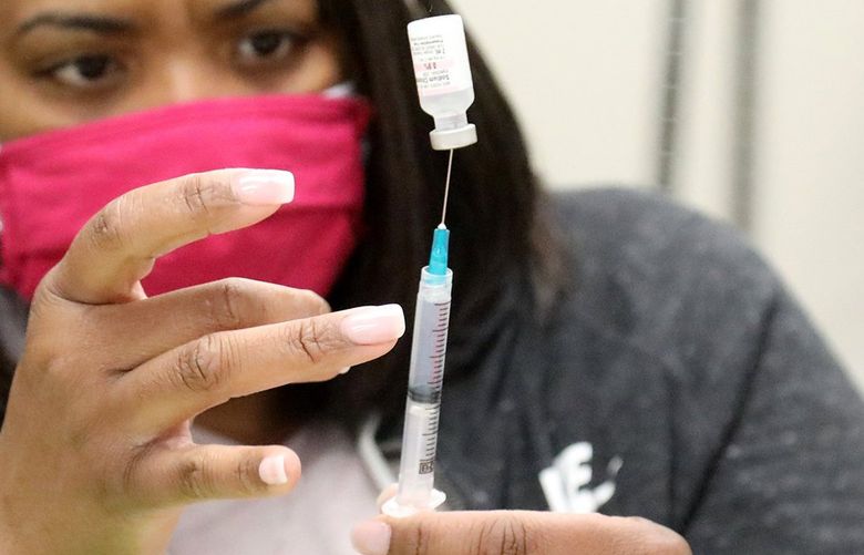 Pharmacy technician Aisha Thomas preps a COVID-19 vaccination syringe to be used at the New Beginnings Christiian Fellowship.
The New Beginnings Christian Fellowship in Kent has been vaccinating people since February a partnership with Fred Hutch and African Americans Reach and Teach Health Ministry. They say that they are filling the gap in vaccine access in South King County. 217041