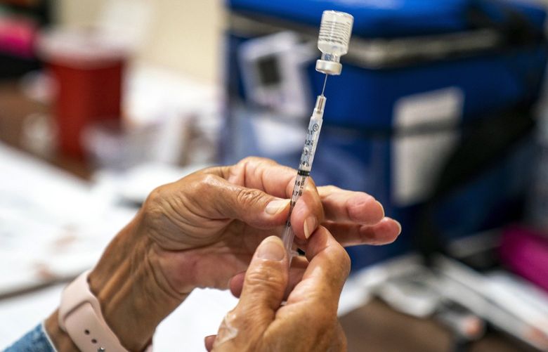 FILE – In this Sept. 14, 2021, file photo, vaccine provider prepares a dose of the COVID-19 vaccine at a clinic run by the Allegheny County Health Department at Casa San Jose, a non-profit serving Latino immigrants in the Beechview neighborhood of Pittsburgh. The number of Americans getting COVID-19 vaccines has steadily increased to a three-month high as seniors and people with medical conditions seek boosters, and government and employer mandates push more workers to take their first doses. (Alexandra Wimley/Pittsburgh Post-Gazette via AP, File) PAPIT504 PAPIT504