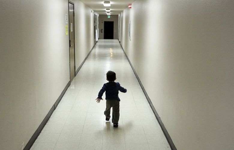 FILE – In this Dec. 11, 2018 file photo, an asylum-seeking boy from Central America runs down a hallway after arriving from an immigration detention center to a shelter in San Diego. The federal government may house unaccompanied migrant children on a California Army National Guard base in central California, officials said. The Pentagon on Friday, April 2, 2021, approved the use of Camp Roberts to temporarily house children traveling alone, according to a defense official.  (AP Photo/Gregory Bull, File) LA650