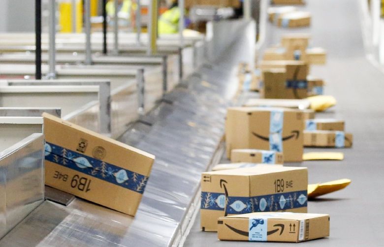 FILE – In this Dec. 17, 2019, file photo, Amazon packages move along a conveyor at an Amazon warehouse facility in Goodyear, Ariz. Amazon’s pandemic boom isn’t showing signs of slowing down. The company said Thursday, April 29, 2021, that its first-quarter profit more than tripled from a year ago, fueled by the growth of online shopping. It also posted revenue of more than $100 billion, the second quarter in row that the company has passed that milestone. (AP Photo/Ross D. Franklin, File) NYDD203
