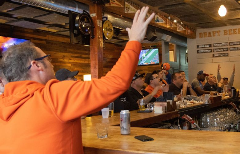 Denver Broncos fans at St. Andrews Bar & Grill cheer as their team scores. Credit: Christy Karras