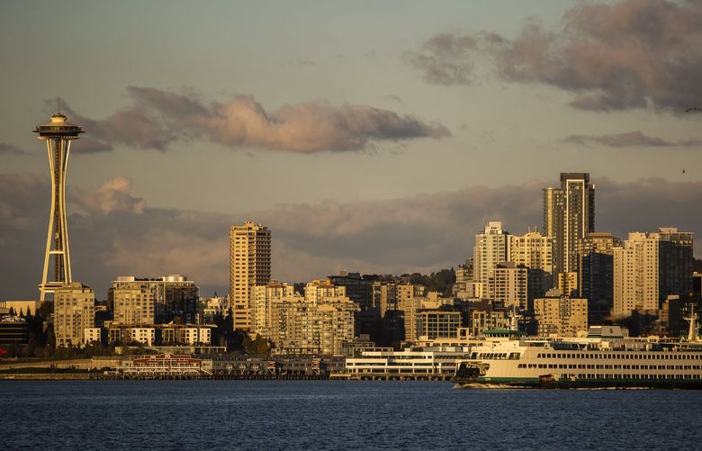 A ferry passes the Seattle skyline during sunset on Monday, Oct. 11, 2021.  218504