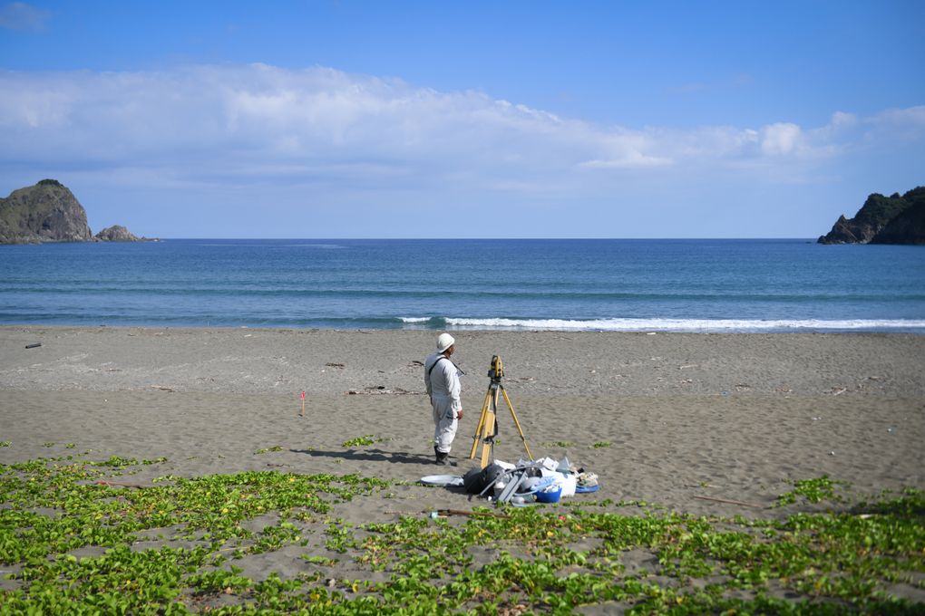 A worker surveying Katoku beach at the site of the planned concrete wall. (Noriko Hayashi / The New York Times)