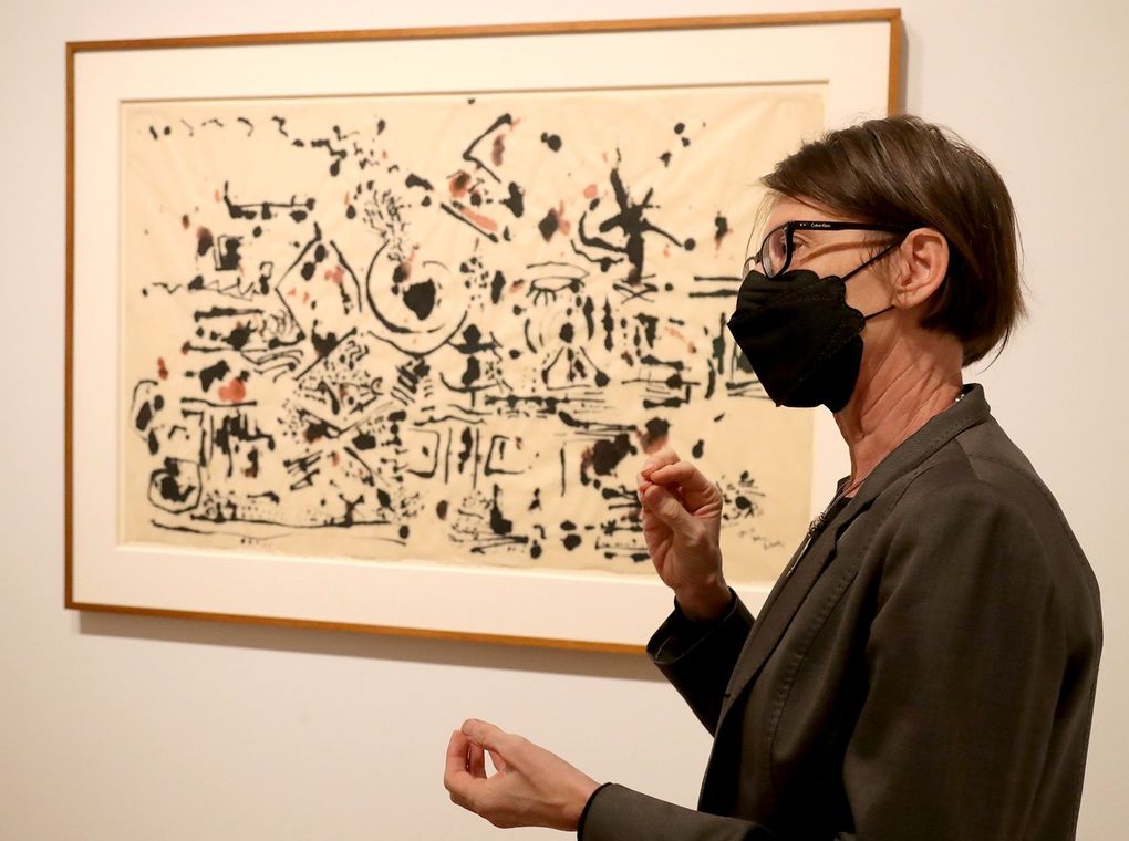 Catharina Manchanda, curator of modern and contemporary art at SAM, describes the artist's intention in âUntitledâ by Jackson Pollock, 1951, one of the works in the âFrissonâ exhibition. (Greg Gilbert / The Seattle Times)
