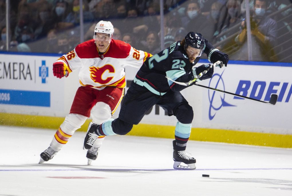 Seattle Kraken Mason Appleton (22) battles the puck with Calgary Flames Michael Stone (26) during the second period of a preseason NHL hockey game at the accesso ShoWare Center in Kent on Oct. 2, 2021. 218368 (Daniel Kim / The Seattle Times)