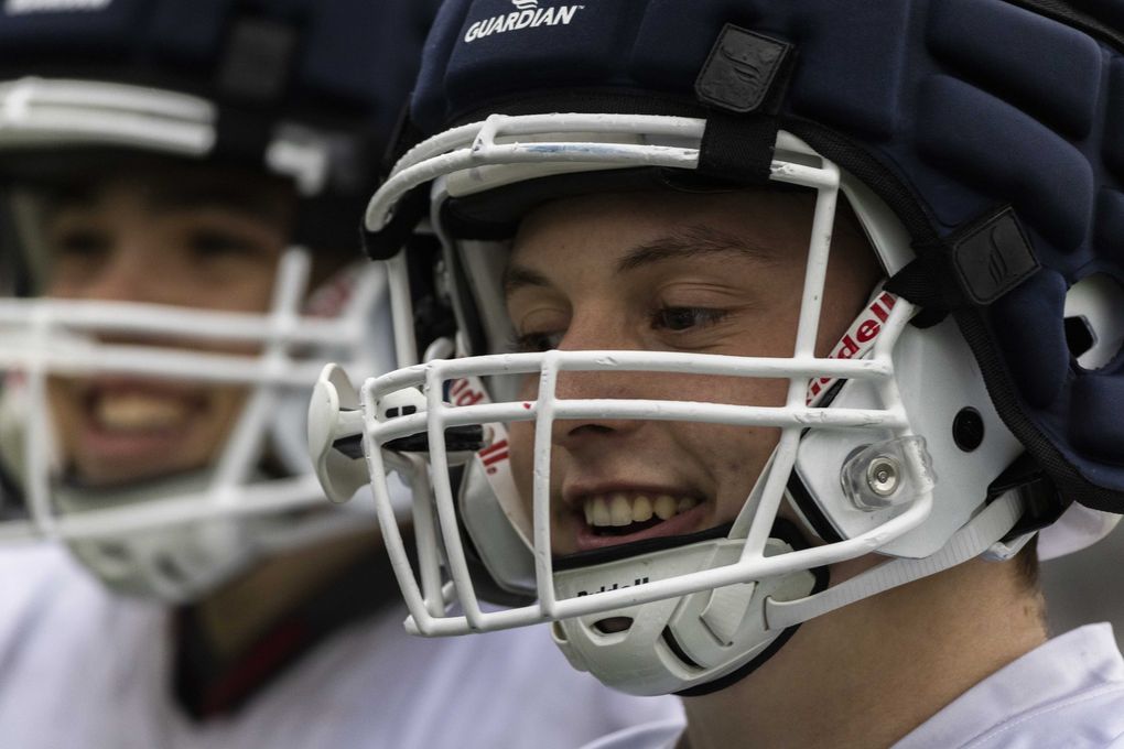 Zach Mclean laughs with fellow teammates during a football practice at Interlake High School in Bellevue on Wednesday, Oct. 27, 2021. Mclean who is legally blind is a junior at Interlake High School. (Daniel Kim / The Seattle Times)