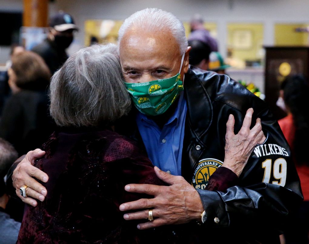 Lenny Wilkens, on his birthday, gets a hug from a fan at a ceremony honoring the Sonics legend with a street named after him, Thursday, Oct. 28, 2021 in Seattle. The ceremony was moved indoors due to rainy weather. (Ken Lambert / The Seattle Times)