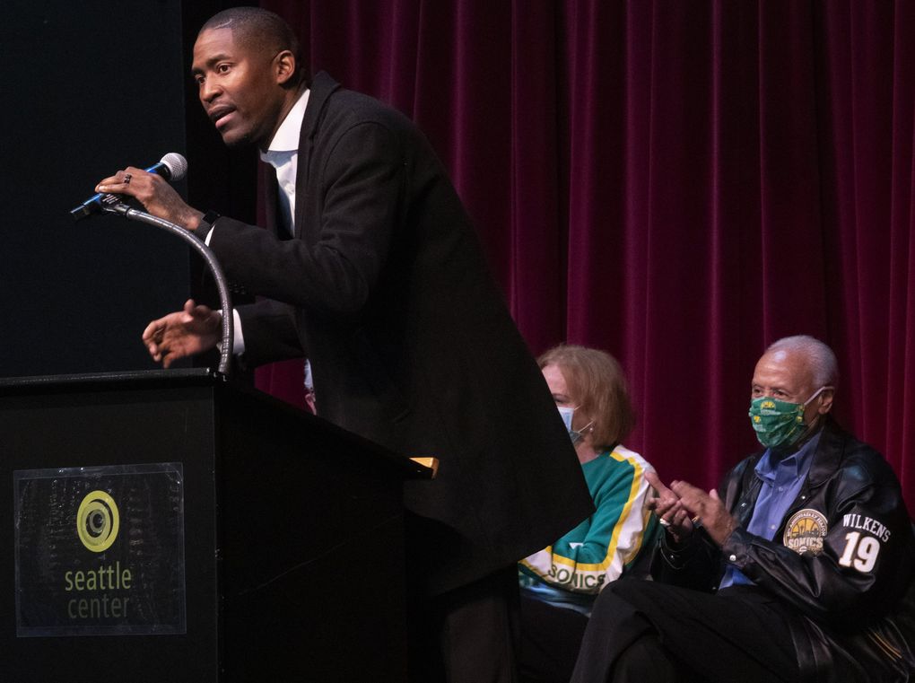 Jamal Crawford, left, speaks at a ceremony for Lenny Wilkens, right, that honors the Sonics legend with a street named after him, Thursday, Oct. 28, 2021 in Seattle. The ceremony was moved indoors due to rainy weather. (Ken Lambert / The Seattle Times)