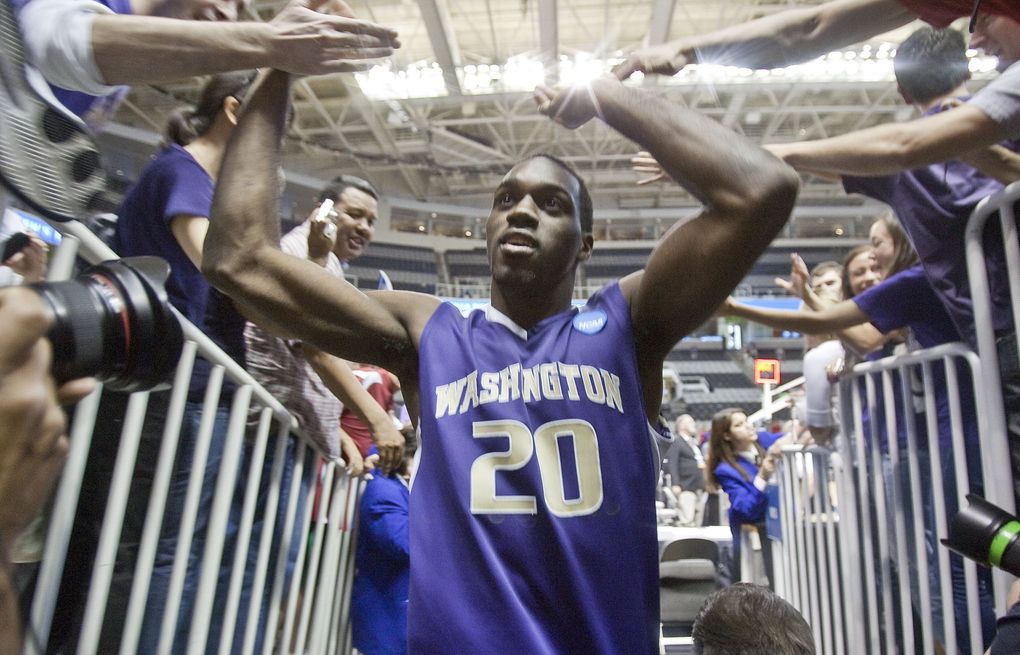 Quincy Pondexter celebrates with Husky fans as he leaves the court following Washington’s 82-64 win over New Mexico in the second round of the NCAA tournament in 2010. (Dean Rutz / The Seattle Times)