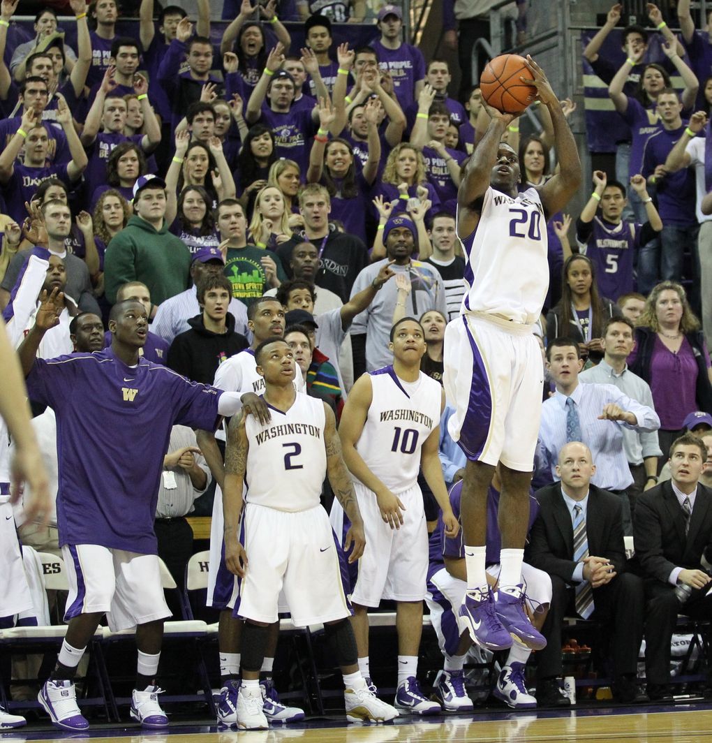 Fans and the Huskies alike watch Washington’s Quincy Pondexter (20) shoot a basket during the Washington Huskies vs. USC Trojans men’s basketball game at Bank of America Arena in Seattle on Feb. 18, 2010. (Cliff DesPeaux / The Seattle Times)