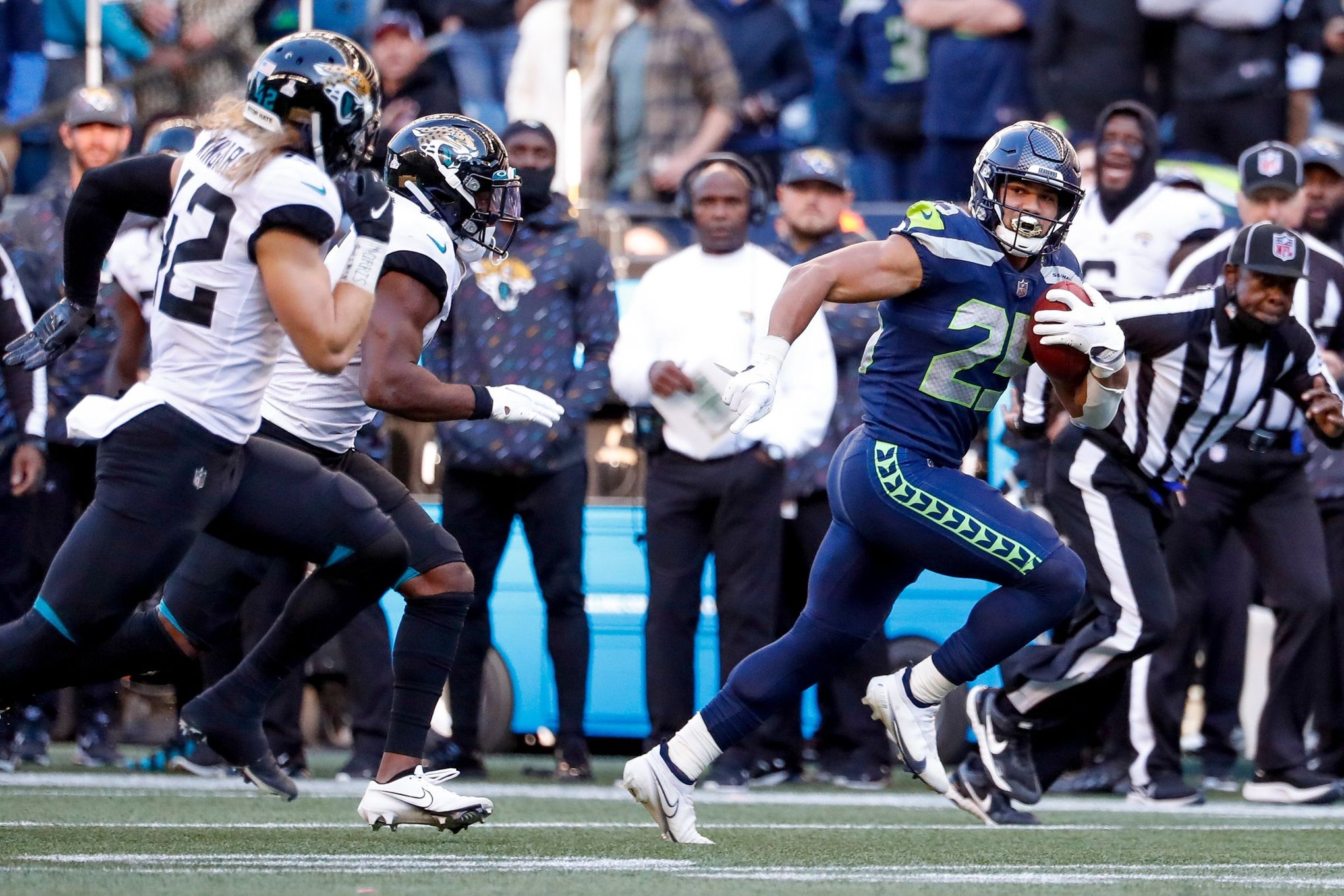 Travis Homer of the Seattle Seahawks runs with the ball in the second