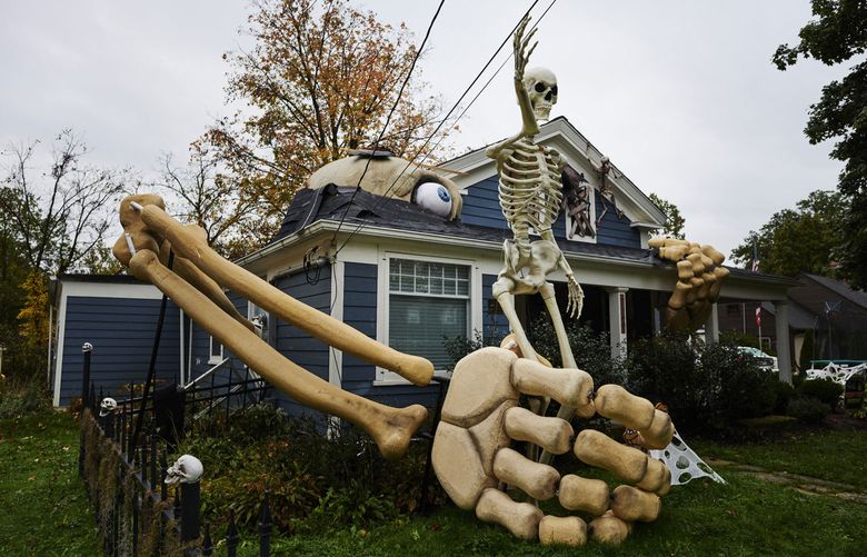 Skeletons and other Halloween decorations fill the yard in front of Alan Perkins’s home in Olmsted Falls, Ohio, on October 22, 2021. (Photo for The Washington Post by Angelo Merendino).