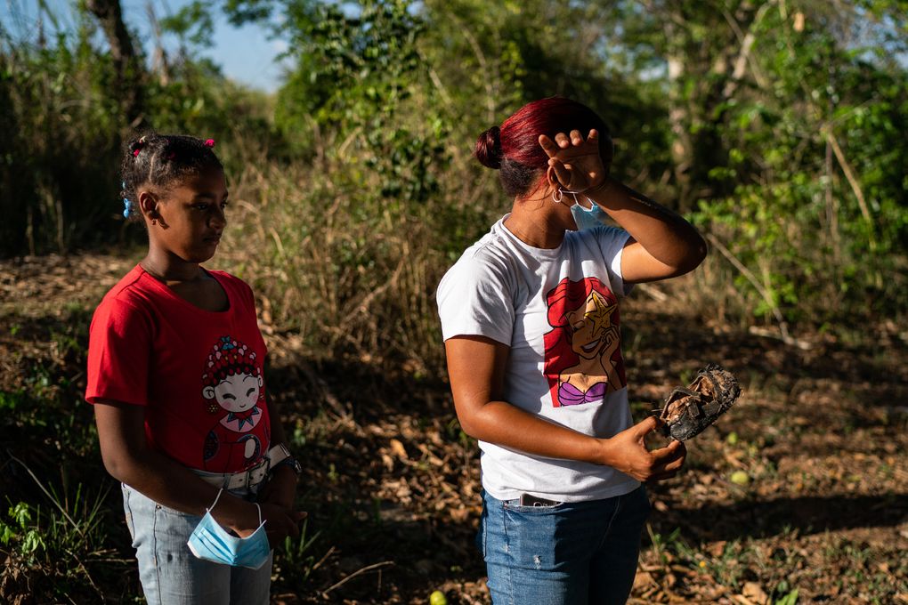 Yeidy Sierra, 10, and her mother Emily Sierra on May 26, 2021, find her shoe that had been lost during a 3 a.m. eviction by Central Romana in January 2016, in El Seibo, Dominican Republic. (Washington Post photo by Salwan Georges)