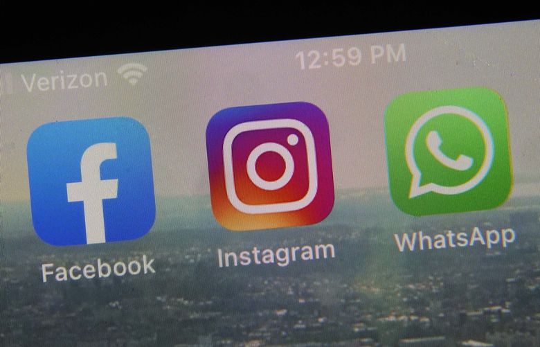 This photo shows the mobile phone app logos for, from left, Facebook, Instagram and WhatsApp in New York, Tuesday, Oct. 5, 2021. The six-hour outage was a headache for many casual users but far more serious for the millions of people worldwide who rely on the social media sites to run their businesses or communicate with relatives, fellow parents, teachers or neighbors. (AP Photo/Richard Drew) NYRD205 NYRD205