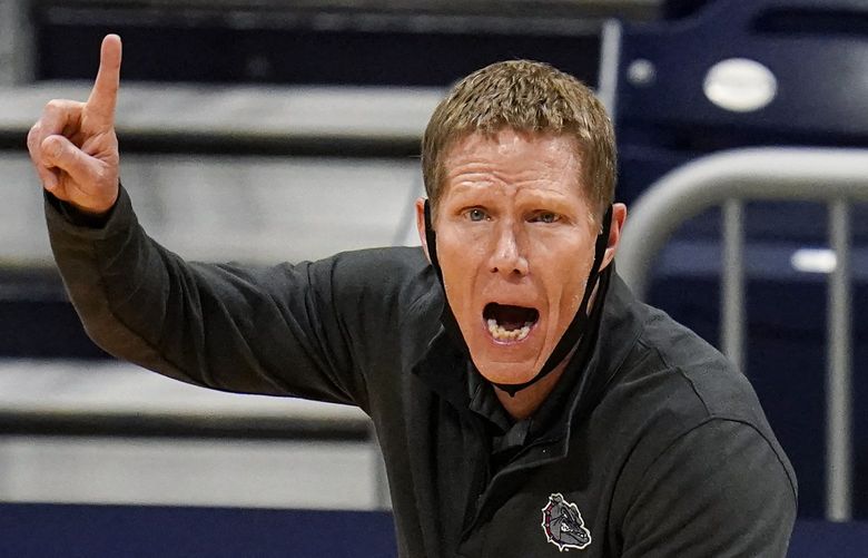 FILE – Gonzaga head coach Mark Few calls a play for his team as they play against Oklahoma in the first half of a second-round game in the NCAA men’s college basketball tournament at Hinkle Fieldhouse in Indianapolis, in this Monday, March 22, 2021, file photo. Gonzaga carried a No. 1 ranking all last season before falling a win short of becoming college basketball’s first unbeaten national champion in 45 years. Mark Few’s Bulldogs start this season in the same position, hoping to complete that final step this time around. The Zags were the runaway top choice in The Associated Press Top 25 men’s college basketball preseason poll released Monday, Oct. 18, 2021. (AP Photo/Michael Conroy, File) NY159 NY159