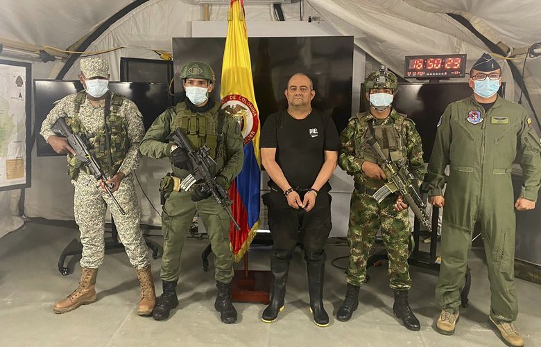 In this photo released by the Colombian presidential press office, one of the countryâ€™s most wanted drug traffickers, Dairo Antonio Usuga, alias â€œOtoniel,â€ leader of the violent Clan del Golfo cartel, is presented to the media at a military base in Necocli, Colombia, Saturday, Oct. 23, 2021.  (Colombian presidential press office via AP) XLAT108 XLAT108