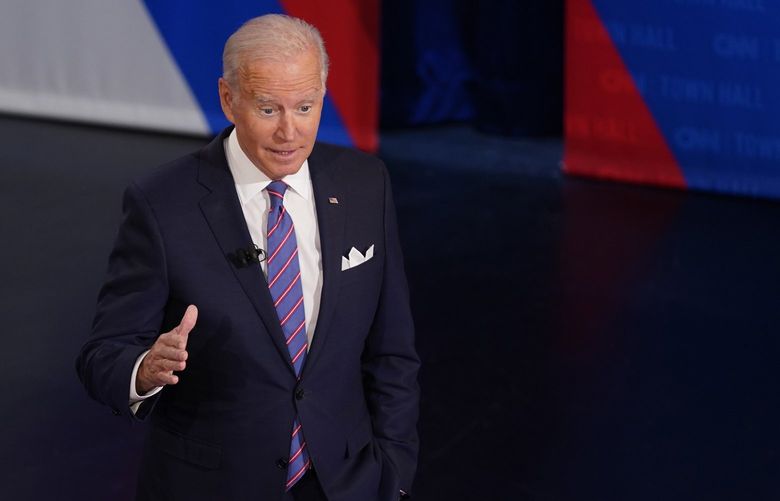 President Joe Biden participates in a CNN town hall at the Baltimore Center Stage Pearlstone Theater, Thursday, Oct. 21, 2021, in Baltimore, with moderator Anderson Cooper. (AP Photo/Evan Vucci) MDEV315 MDEV315