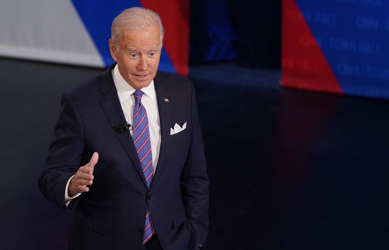 President Joe Biden participates in a CNN town hall at the Baltimore Center Stage Pearlstone Theater, Thursday, Oct. 21, 2021, in Baltimore, with moderator Anderson Cooper. (AP Photo/Evan Vucci) MDEV315 MDEV315