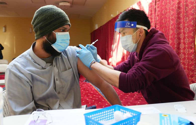 Mahmoud Bishr receives his COVID-19 vaccine at an ICHS pop-up COVID-19 vaccine clinic with the Redmond Islamic Center on March 30, 2021. 