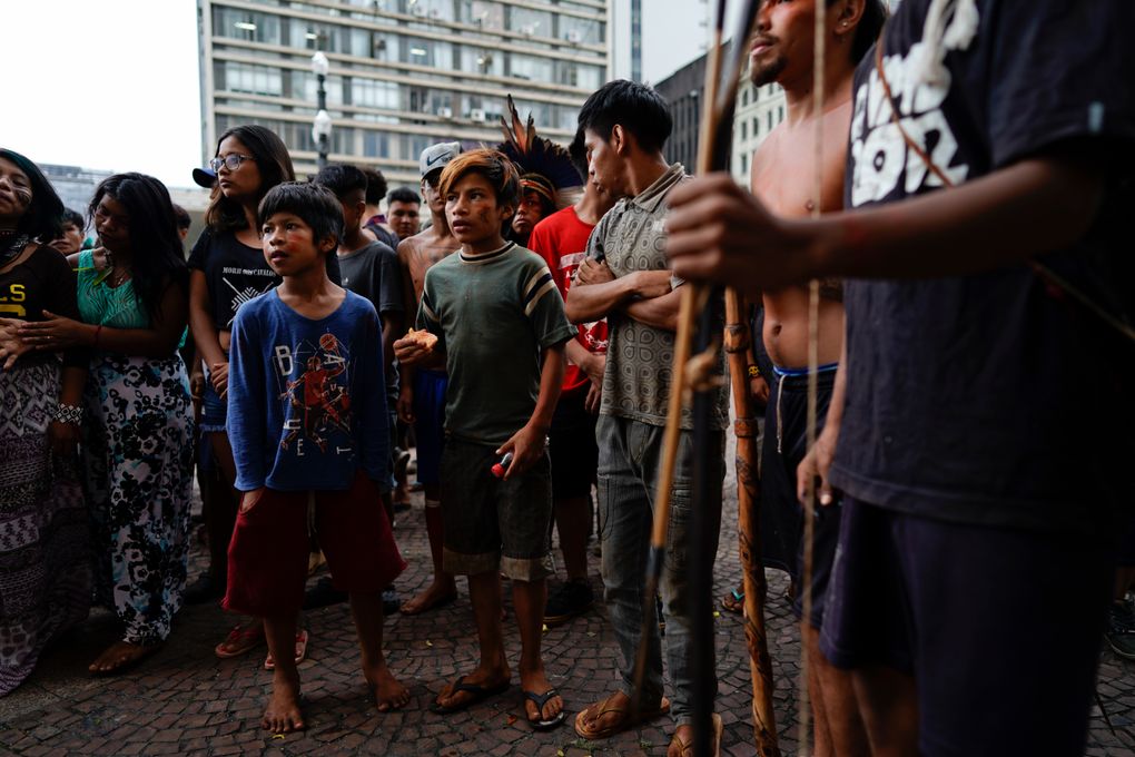 Indigenous people stand outside Sao Paulo’s City Hall during a demonstration on March 27, 2018. On Friday, Oct. 22, The Associated Press reported on stories circulating online incorrectly asserting that a video showed aboriginal people in Australia defending themselves with bows and arrows against authorities trying to forcibly administer COVID-19 vaccines. In fact, the video showed a group of Guarani Indigenous people in Sao Paulo, Brazil, demonstrating against health-care policy changes in March 2019. (AP Photo/Victor R. Caivano)