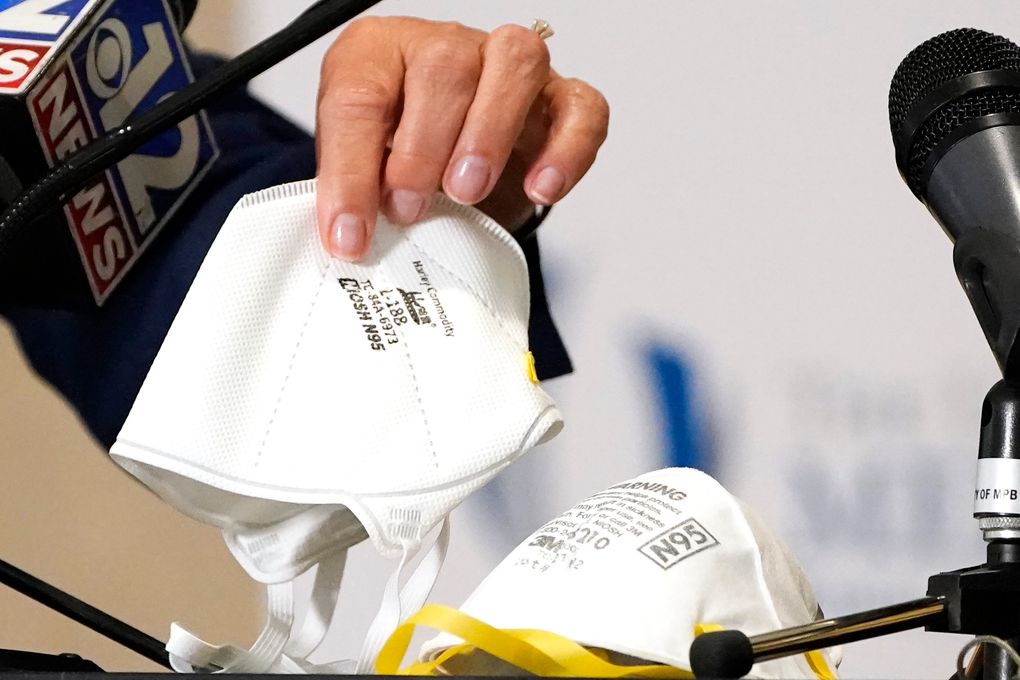 Dr. LouAnn Woodward, vice chancellor for health affairs and dean of the School of Medicine at the University of Mississippi Medical School, displays two of the acceptable N95 face masks included in a COVID-19 policy in Jackson, Miss. On Friday, Oct. 15, The Associated Press reported on stories circulating online incorrectly claiming a 2018 study that looked at the effectiveness of N95 masks versus medical masks found that masks don’t stop the spread of viruses. (AP Photo/Rogelio V. Solis, File)