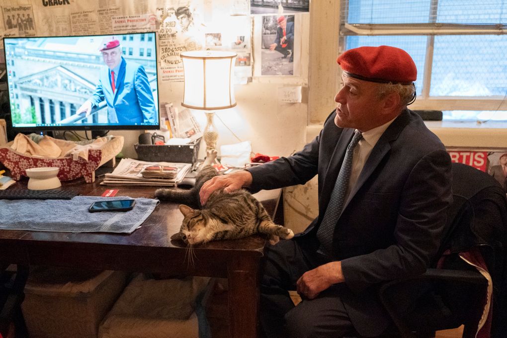 New York City Republican mayoral candidate Curtis Sliwa pets one of his cats as he speaks during an interview with The Associated Press in his apartment, Tuesday, Oct. 12, 2021, in New York. (AP Photo/Mary Altaffer)