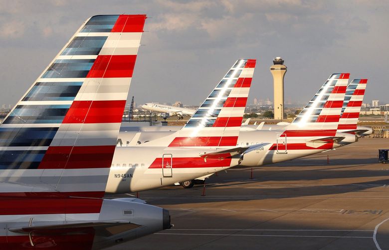 American Airlines jets are parked at Dallas-Fort Worth International Airport’s Terminal C, Sunday, April 19, 2020. (Tom Fox/The Dallas Morning News/TNS) 31036283W 31036283W