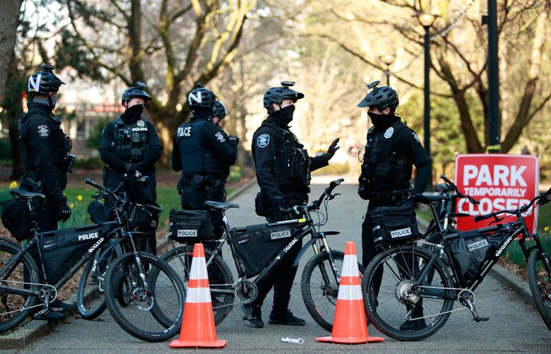Seattle Bike Police block an entry to Denny Park during an encampment removal in Seattle Wednesday, March 3, 2020. 216551