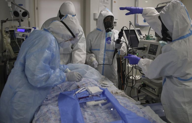 Medical staff members wearing special suits to protect against coronavirus treat a patient with coronavirus at an ICU at the Regional Clinical Hospital 1, in Krasnodar, south Russia, Tuesday, Nov. 2, 2021. Coronavirus deaths in Russia hit another daily record several days after a nationwide order for many Russians to stay off work took effect. Russia’s state coronavirus task force has reported record daily infections or deaths almost every day for the last month. (AP Photo/Vitali Timkiv) XAZ108 XAZ108