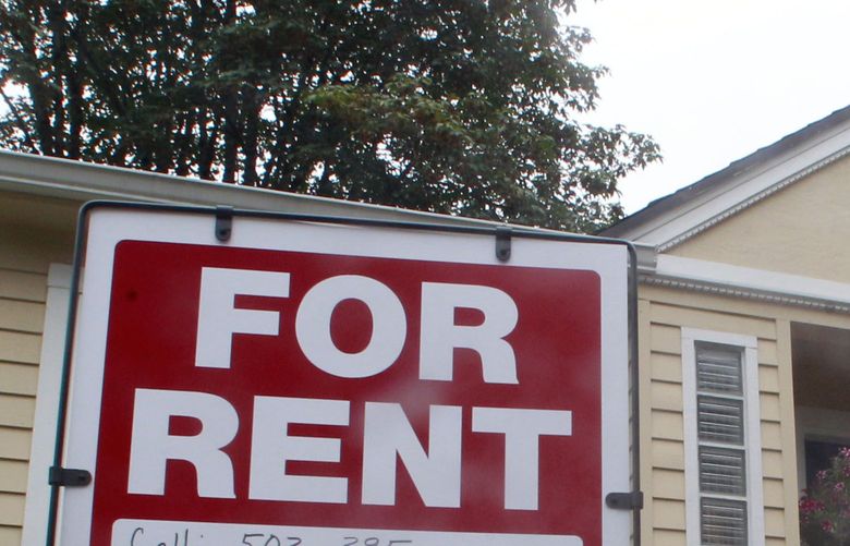 This 2011, photo shows a house for rent and for sale sign in front of a home in Portland, Ore.  (AP Photo/Rick Bowmer)
