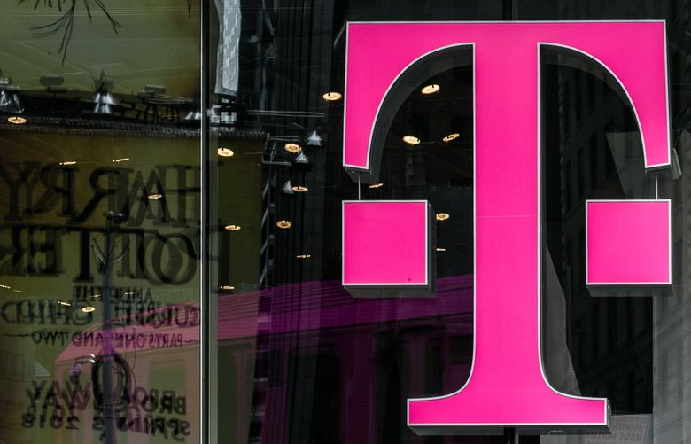 A T-Mobile US Inc. logo is displayed on a store location in New York, U.S., on Monday, April 30, 2018. Sprint Corp. suffered its worst stock decline in almost six months, rocked by fears that a proposed $26.5 billion takeover by T-Mobile US Inc. will get rejected by antitrust enforcers. Photographer: Jeenah Moon/Bloomberg 775159566