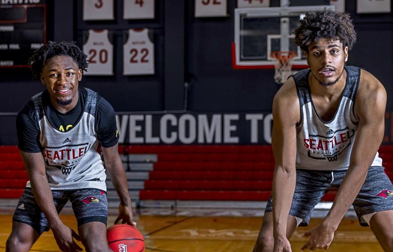 Seattle University basketball players Darrion Trammell, left, and Riley Grigsby dribble basketballs at Seattle UniversityÃÂs Redhawk Center on Friday, Oct. 29, 2021. 218640